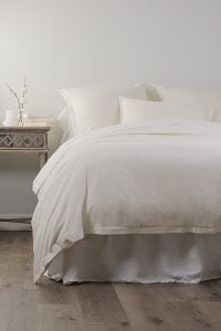 Amity home pure duvet cover   ivory duvet cover with subtle woven texture draped on a styled bed with matching pillows