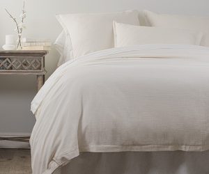 Amity home pure duvet cover   ivory duvet cover with subtle woven texture draped on a styled bed with matching pillows