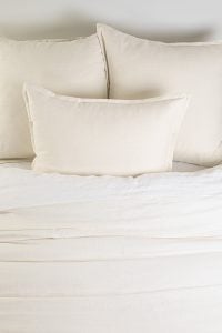 Amity home pure duvet cover   ivory textured bedding styled on a bed with matching pillows showing soft luxurious fabric