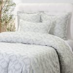 Amity home dawson french ikat duvet cover and shams in sea glass and white featuring a subtle geometric pattern on a styled bed