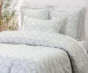Amity home dawson french ikat duvet cover and shams in sea glass and white featuring a subtle geometric pattern on a styled bed
