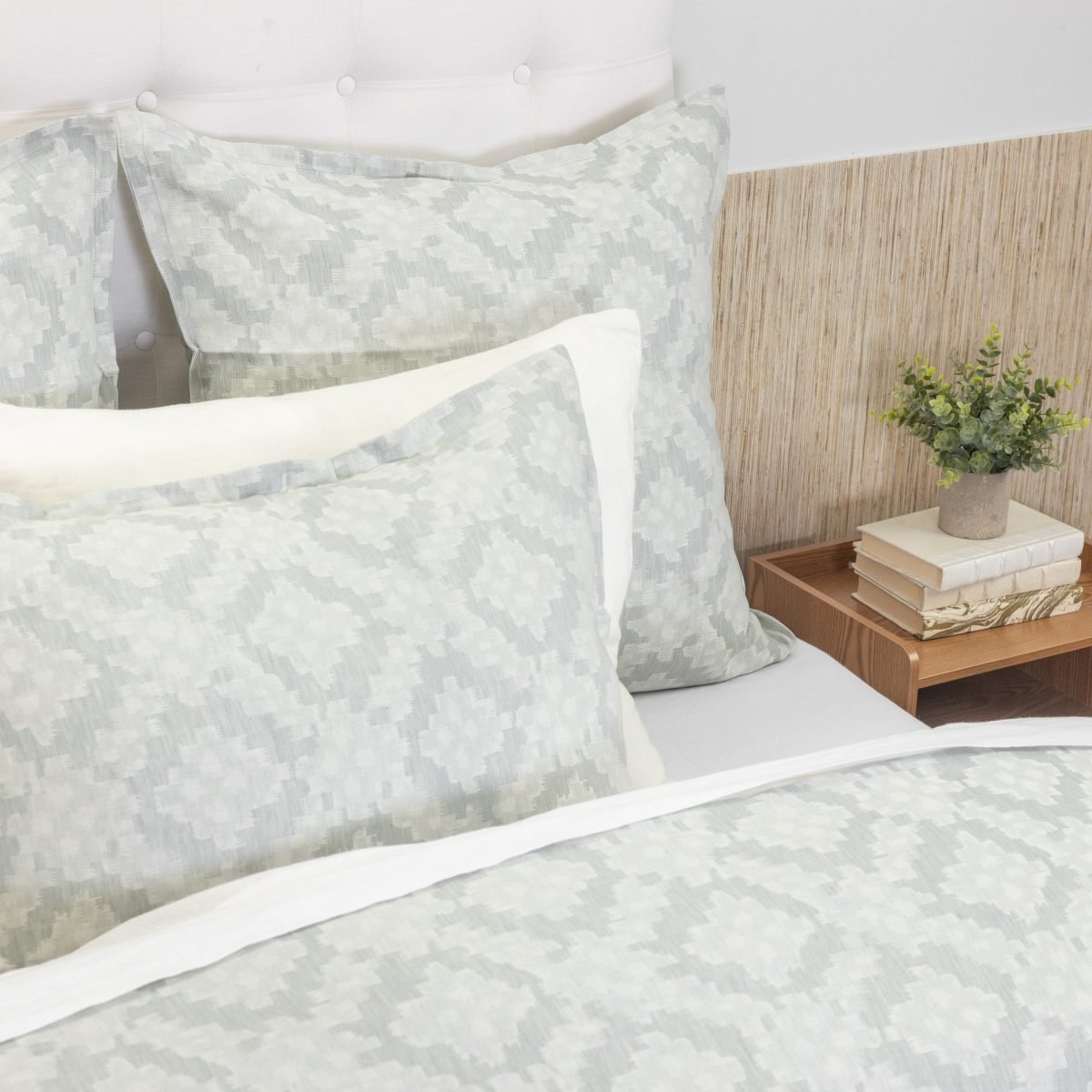 Amity home dawson french ikat duvet cover and shams in sea glass and white with a soft geometric pattern on a styled bed