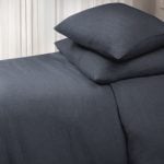 Amity home damara duvet cover   steel blue linen bedding set with two stacked pillows showcasing a subtle textured weave