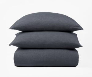 Amity home damara duvet cover and two pillow shams in steel blue with a subtle linen texture neatly stacked