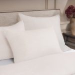 Amity home damara duvet cover in ivory with a subtle textured weave styled on a bed with matching pillows
