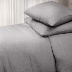 Amity home damara duvet cover and pillows in grey chambray showing soft textured weave on a styled bed