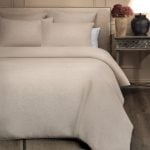 Amity home damara duvet cover   natural beige linen blend fabric styled on a bed with matching pillow shams