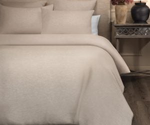 Amity home damara duvet cover   natural beige linen blend fabric styled on a bed with matching pillow shams