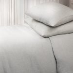 Amity home damara duvet cover   luxurious sea glass linen bedding with a soft texture styled on a bed with two matching pillows
