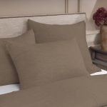 Amity home damara duvet cover in walnut brown featuring a soft textured fabric styled on a bed with matching pillow shams