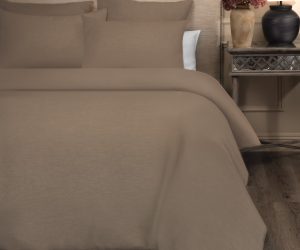 Amity home damara duvet cover in walnut brown styled on a bed with matching shams showing its subtle woven texture