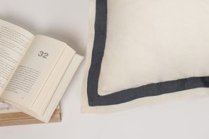 Amity home orfeo linen duvet cover   close up of ivory linen with a steel blue framed border and visible texture