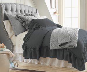 Amity home caprice duvet cover   steel blue ruffled linen look duvet cover on a styled bed with quilted grey accents