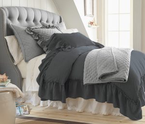 Amity home caprice duvet cover   steel blue ruffled linen look duvet cover on a styled bed with quilted grey accents