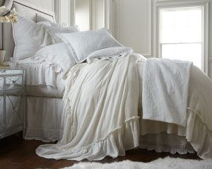 Amity home caprice duvet cover   ivory ruffled duvet cover draped on a luxurious bed with layered pillows and a crochet throw