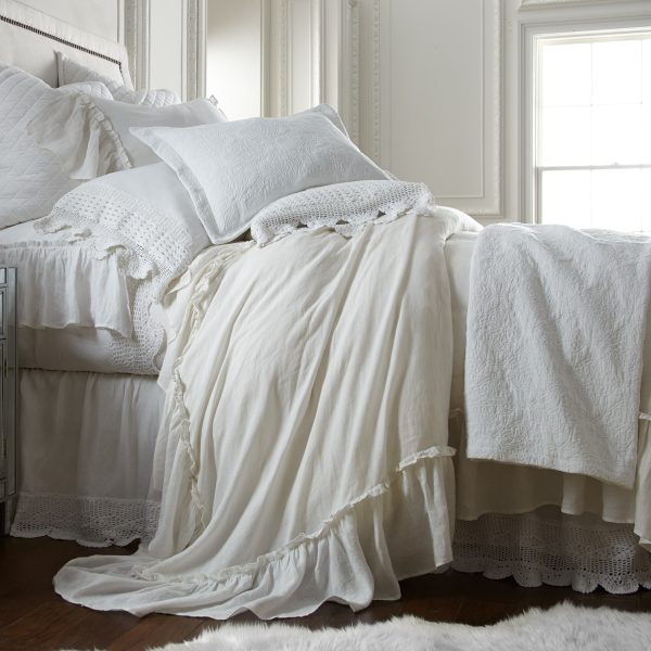 Amity Home Caprice Duvet Cover - Ivory ruffled duvet cover draped on a luxurious bed with layered pillows and a crochet throw.