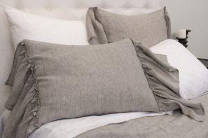 Amity home caprice duvet cover and shams in grey chambray with elegant ruffled edges styled on a bed