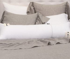 Amity home caprice duvet cover   grey chambray bedding set with ruffled shams and a white lumbar pillow on a styled bed