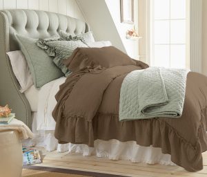 Amity home caprice duvet cover   walnut brown ruffled duvet cover on a styled bed with a green quilted throw