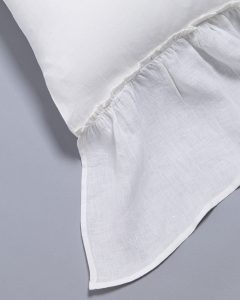 Amity home caprice duvet cover   close up of white linen look fabric with a delicate ruffled edge and visible weave