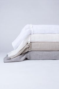 Amity home caprice duvet covers stacked in white cream beige and grey chambray with ruffled edges