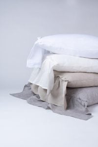 Amity home caprice duvet cover   grey chambray duvet cover with ruffled edge stacked with natural and white linen bedding