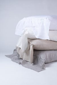 Amity home caprice bedding shams stacked showing white natural and grey chambray linen textures with ruffled and tie details