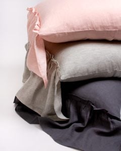 Amity home caprice duvet cover   stack of ruffled linen bedding in petal pink light grey and charcoal showcasing soft texture