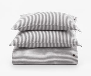 Amity home brayden grey stripes duvet cover set   folded duvet cover and two stacked pillow shams with thin grey and white stripes natural woven texture and brown button details