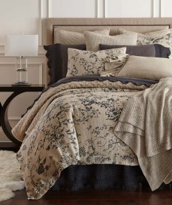 Amity home le poet linen duvet cover   steel blue ornate floral pattern on natural beige linen styled on a luxurious bed