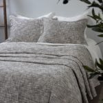 Amity home evol duvet cover   charcoal textured woven bedding with two matching shams on a bed