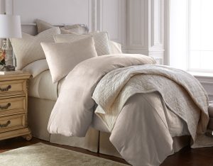 Amity home lia rayon velvet duvet cover   oyster rayon velvet duvet cover and matching pillows on a styled bed with a quilted throw