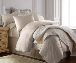 Amity home lia rayon velvet duvet cover   oyster rayon velvet duvet cover and matching pillows on a styled bed with a quilted throw