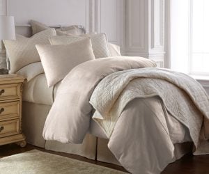 Amity home lia rayon velvet duvet cover   oyster rayon velvet duvet cover and matching pillows on a styled bed with a quilted throw