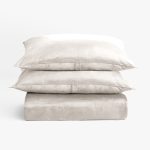 Amity home lia rayon velvet duvet cover in oyster stacked with two matching pillows showing soft luxurious texture