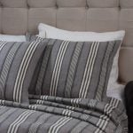 Amity home langston linen duvet cover   grey with vertical off white stripes draped on a bed with matching pillow shams and a tufted headboard