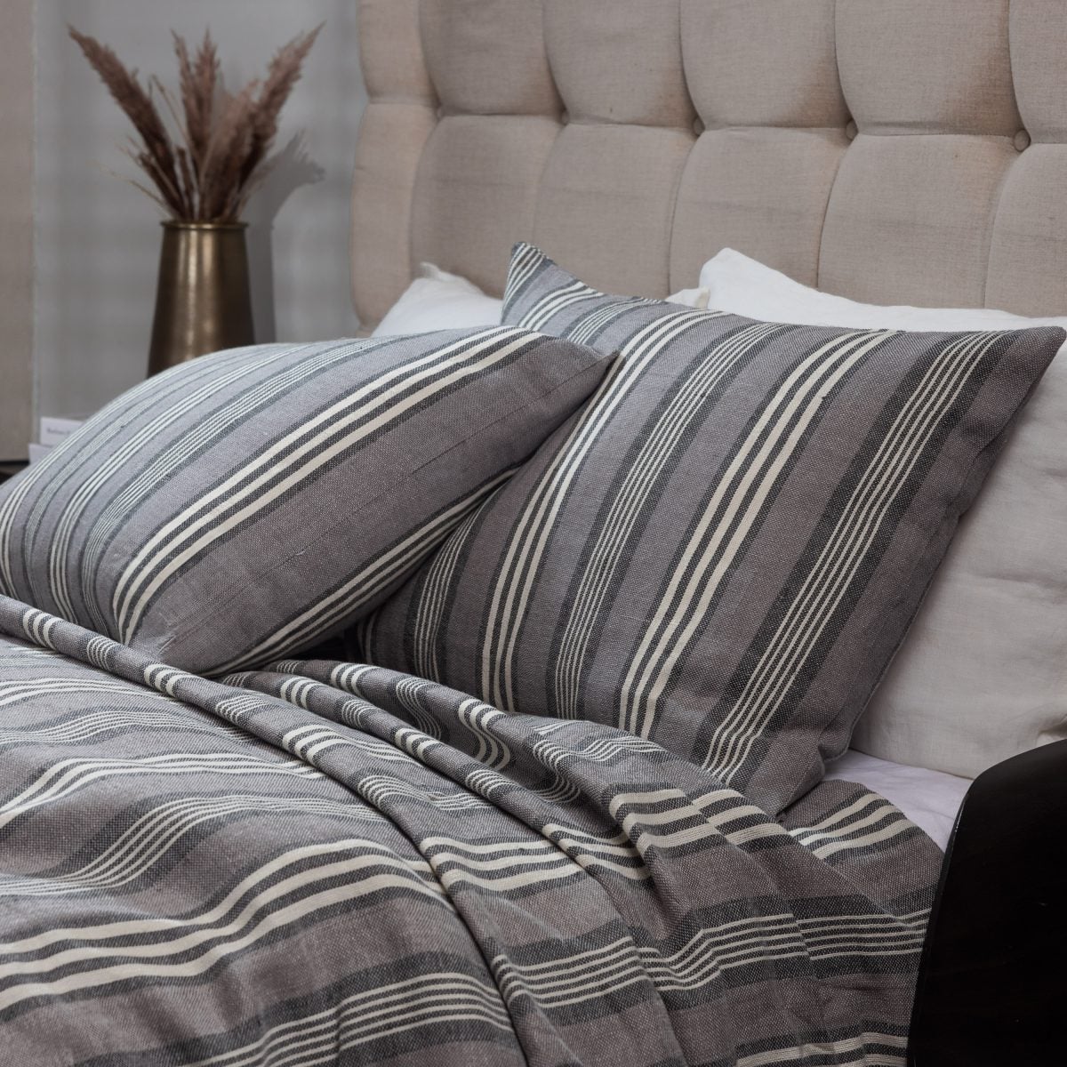 Amity home langston linen duvet cover   grey linen duvet and matching pillows with varied white stripes on a styled bed