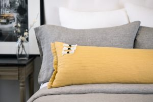 Amity home cambria bolster in ochre   tassel accents