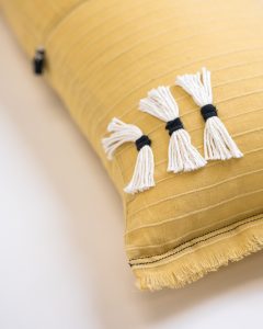 Amity home cambria bolster in ochre   decorative tassels