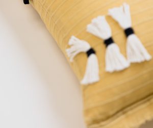 Amity home cambria bolster in ochre   white tassels