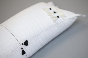 Amity home cambria bolster in white   black tassels