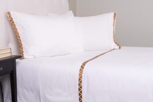Amity home turin sheet set in white with ochre   embroidered triangle trim