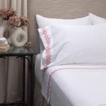 Amity home amalfi sheet set in white with coral   geometric interlocking embroidery