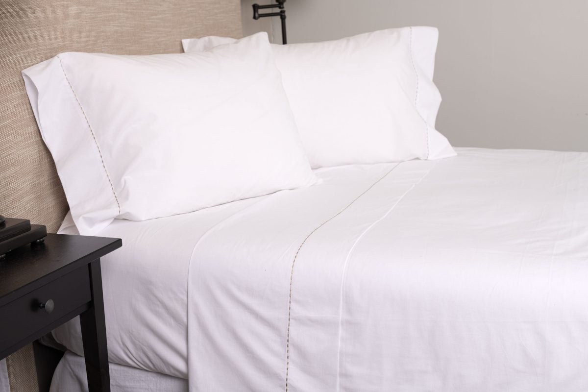 Amity home talo sheet set in white with caramel stitching   dotted stitch detail