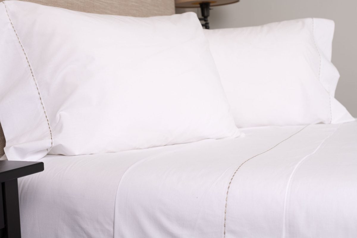 Amity home talo sheet set in white with caramel stitching   dashed border detail