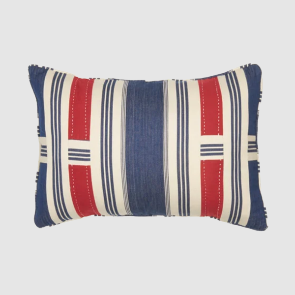Rectangular striped pillow in red white and blue on a light gray background