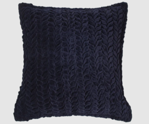 Square navy blue decorative pillow with chunky knitted texture on a light background