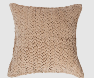 Beige decorative throw pillow with a chunky braided knitted pattern
