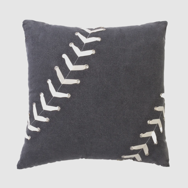 Decorative navy pillow with white curved stitch embellishments along diagonal seams on dark fabric.