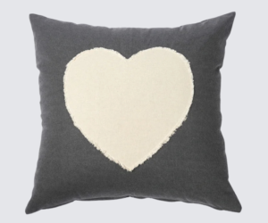 Dark gray throw pillow with a large cream heart appliqué in the center